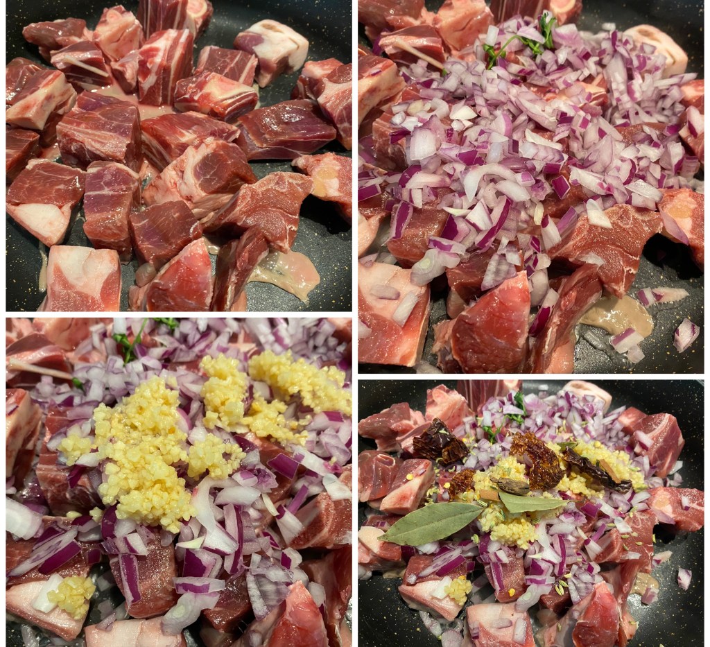 Close-up of raw meat cubes in a frying pan.