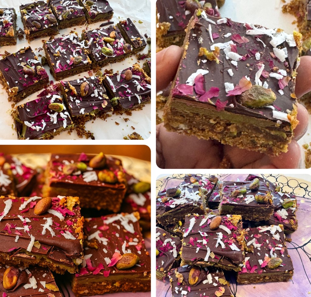 A close-up image of chocolate-covered bars topped with pistachios, coconut flakes, and dried rose petals, arranged neatly on a surface.