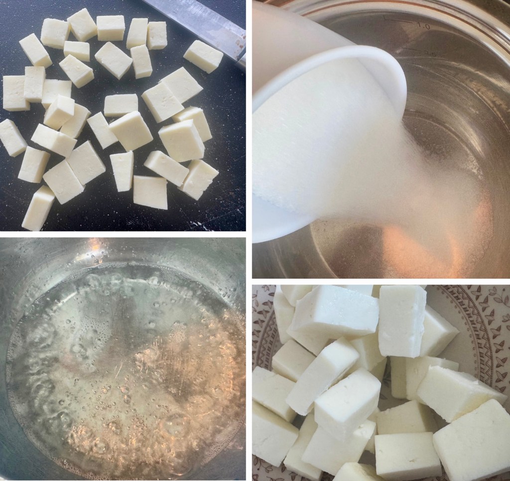 Diced pieces of paneer cheese on a cutting board.