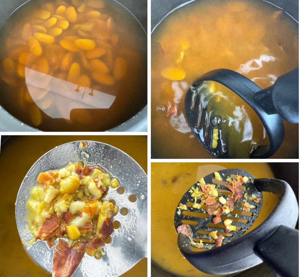 Close-up of boiling beans in a pot with a reflective surface.